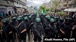 Militantes armados de Hamás conmemoran otro aniversario del grupo en la ciudad de Gaza, en diciembre de 2014. (AP/Khalil Hamra, File)