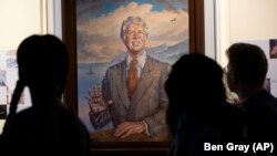 Visitantes pasan frente a un retrato del presidente Jimmy Carter durante una celebración por su cumpleaños 99 en el Centro Carter, el sábado 30 de septiembre de 2023, en Atlanta. (AP Foto/Ben Gray)