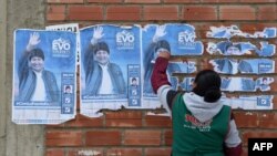 Una mujer quita los posters de Evo Morales en El Alto el pasado 11 de noviembre. Aizar RALDES / AFP