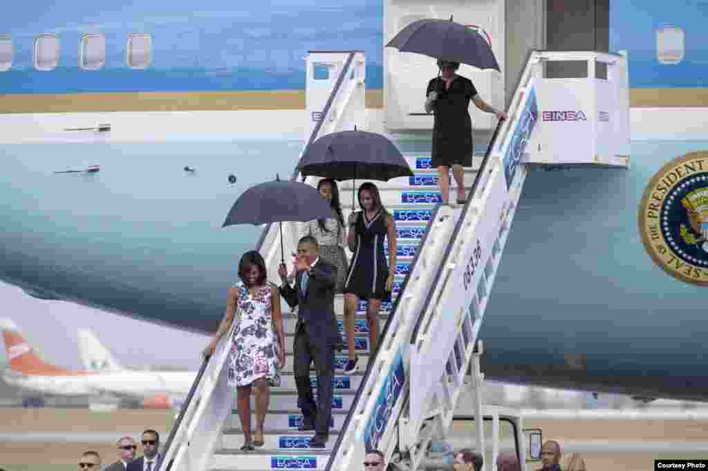 Obama y su familia comienzan a bajar las escaleras del avión presidencial.