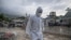 Un forense camina entre los escombros de edificios dañados por los terremotos del 24 de junio, en Tanaguarena, estado de La Guaira (Venezuela).