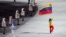 Antonio Pardo (d) porta la bandera de Venezuela durante la ceremonia de inauguración de los XXII Juegos Olímpicos de Invierno en la ciudad rusa de Sochi
