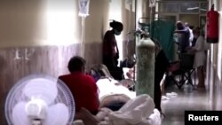 Enfermos en los pasillos de un hospital en Cuba que atiende a pacientes de COVID-19. (Captura de video/Reuters)