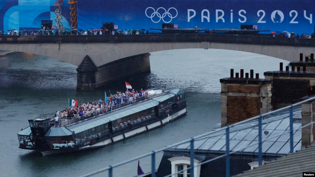 Juegos Olímpicos de París 2024 - Ceremonia de apertura - París, Francia - 26 de julio de 2024. Atletas a bordo de un barco en el desfile flotante en el río Sena durante la ceremonia de apertura. (Pool via REUTERS/Peter Cziborra)