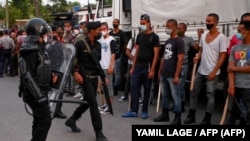 La policía antidisturbios recorre las calles luego de una manifestación contra el gobierno de Miguel Díaz-Canel en el municipio de Arroyo Naranjo, La Habana el 12 de julio de 2021. 