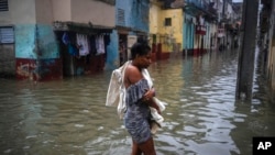 Una mujer atraviesa una calle inundada en La Habana, el viernes 3 de junio. (AP/Ramon Espinosa)