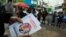 Un votante sostiene un volante con la imagen de los candidatos presidenciales Gustavo Petro y Rodolfo Hernández, en Bogotá, Colombia. (REUTERS/Luisa Gonzalez)