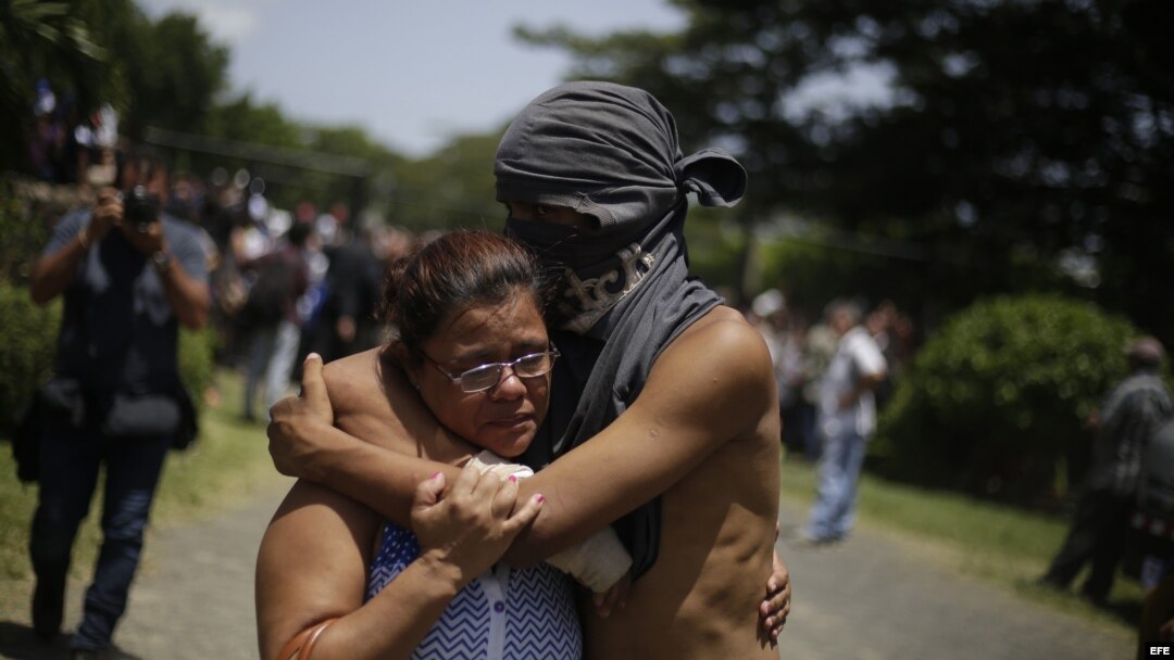 Un estudiante abraza a un familiar luego de salir del resguardo en la parroquia Divina Misericordia, en Managua.