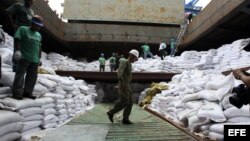 Un grupo de trabajadores desvela varios contenedores ocultos entre sacos de azúcar y que presumiblemente contienen material bélico, dentro del barco norcoreano Chong Chon Gang hoy, martes 16 de julio de 2013, en el muelle de Manzanillo en Colón (Panamá). 