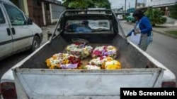Coronas funerarias en la parte posterior de una camioneta en La Habana.