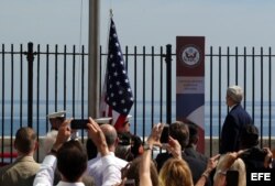 El secretario de Estado, John Kerry (d), presencia el izado de la bandera estadounidense en la embajada en La Habana.