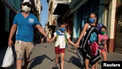 Susana Valdés lleva a su hijo a casa, junto a su esposo, en La Habana, el 23 de marzo del 2020.