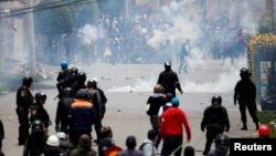 Partidarios del ex presidente Evo Morales y opositores chocan el lunes en una calle de La Paz después que Morales anunciara su renuncia el domingo (Foto: Carlos Garcia Rawlins/Reuters).