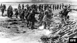 (Archivo) Marines británicos recopilan el armamento de los soldados argentinos 