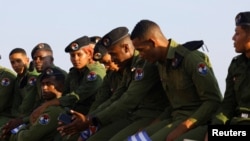 Oficiales de la Brigada Especial Nacional (BEN) del MININT sentados en el muro del Malecón durante el desfile del 1ro de Mayo, en La Habana.