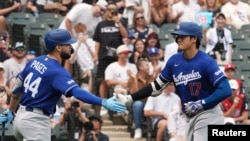 Andy Pagés (44) y Shohei Ohtani (17) apuntan hacia el Juego de las Estrellas el mes próximo. 