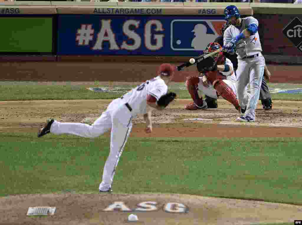 José Bautista (d) de los Azulejos batea una bola de sacrificio lanzada por Patrick Corbin (i) de los Cascabeles durante el Juego de las Estrellas de la MLB. 