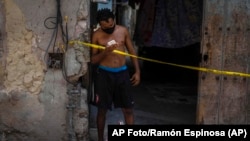 Un hombre frente a una vivienda en cuarentena, en La Habana. (AP Foto/Ramón Espinosa)