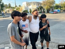 El reguetonero cubano radicado en Estados Unidos El Taiger posa para una foto con fanáticos en una calle de Varadero, provincia de Matanzas, el 5 de abril de 2024.