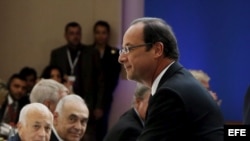 El presidente de Francia Francois Hollande (dch) saluda a la Secretaria de Estado estadounidense Hillary Clinton