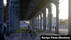 Un trabajador cruza en bicicleta una vía férrea en La Habana, Cuba, el 15 de julio de 2026. (REUTERS/Norlys Pérez)