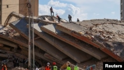 Rescatistas y militares venezolanos en edificio colapsado en La Guaira luego del doble terremoto del pasado 24 de junio. (REUTERS)