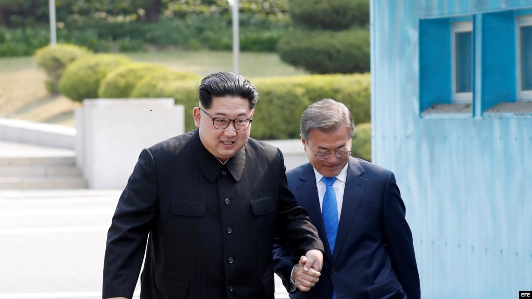 El dictador norcoreano, Kim Jong-un (d), y el presidente surcoreano, Moon Jae-in (i), se dan la mano mientras caminan por la Zona Desmilitarizada en Panmunjom (Corea del Sur), 27 de abril de 2018.