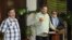 El segundo jefe de las (FARC) Luciano Marín (c), alias Iván Márquez, lee un comunicado, junto a sus compañeros Seuxis Paucias Hernández Solarte, alias Jesús Santrich (d), y y Luis Alberto Albán, alias Marco León Calarcá (i).Nov 29/2013.