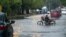 Un hombre conduce una motocicleta por una calle inundada el miércoles en La Habana.