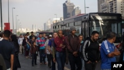 Venezolanos esperan en largas filas para abordar los autobuses en medio de otro apagón generalizado.