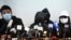 Familiares y abogados de los 12 de Hong Kong durante una conferencia de prensa (Peter Parks / AFP).