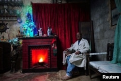 Ángel Ochoa, de 65 años, posa para una foto en su casa con adornos navideños en Rincón, Cuba, 16 de diciembre de 2023. REUTERS/Alexandre Meneghini