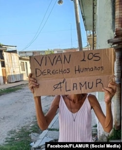 Activista de FLAMUR protesta en una calle del interior de Cuba.