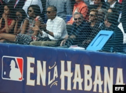 Barack Obama (c), su esposa, Michelle Obama (3i, sus hijas), y Raúl Castro (3d), asisten al juego de béisbol entre el equipo de Cuba y los Rayos de Tampa Bay.