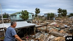 TOPSHOT - David Hester inspects damages of his house after Hurricane Helene made landfall in Horseshoe Beach, Florida, on September 28, 2024.