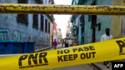 Cintas amarillas de la policía prohíben el paso a un barrio en cuarentena por COVID-19 en La Habana. (Yamil LAGE / AFP)