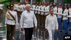 Cuba's President Miguel Diaz-Canel (C) and Colombia's President Gustavo Petro (R) review an honor guard during a welcoming ceremony at the Palace of the Revolution in Havana on July 31, 2026. (Photo by Ramon Espinosa / POOL / AFP)