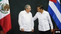 El presidente de México Enrique Peña Nieto conversa con el gobernante cubano Raúl Castro (d-i), durante la ceremonia protocolaria en el Palacio de Gobierno del estado de Yucatán, Mérida (6 de noviembre, 2015).