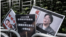 Carteles con imágenes de los libreros Lee Bo (izq.) y Gui Minhai (der.)