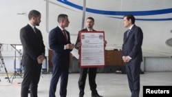 Marco Rubio listens to Edwin F. López, aggregate of National Security Research of the DHS, next to the US plane seized by the USA, on February 6, 2025. (Mark Schiefelbein, Reuters)