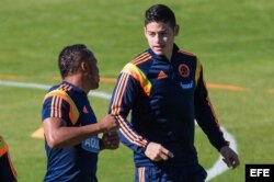 James Rodríguez (d) y Camilo Zúñiga (i) de la selección Colombia participan en un entrenamiento de su equipo en Cotía (Brasil).