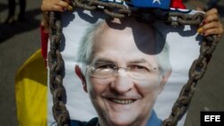 Una mujer sostiene un afiche con la imagen del alcalde mayor de Caracas, Antonio Ledezma, hoy, viernes 20 de febrero de 2015, durante una manifestación para rechazar la detención del político, en Caracas (Venezuela). El opositor y alcalde metropolitano de Caracas fue detenido por agentes del Servicio Bolivariano de Inteligencia (Sebin) el pasado jueves y será procesado -según explicó el presidente de Venezuela, Nicolás Maduro- "por todos los delitos cometidos contra la paz del país".
