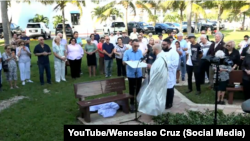 El padre Ángel Andrés González bendice el banco dedicado a las víctimas del remolcador 13, y a todos los cubanos perecidos en el Estrecho de la Florida.