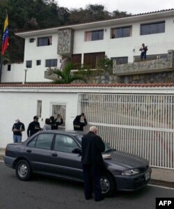 Agentes de la Dirección General de Contrainteligencia Militar (DGCIM) el 23 de febrero de 2014 frente a la casa del general opositor venezolano Angel Vivas Perdomo (Foto: Archivo/AFP).