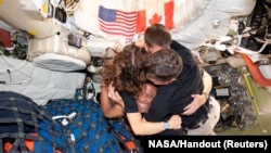 La tripulación de la misión Artemis II de la NASA se abraza en el interior de la nave espacial Orion.