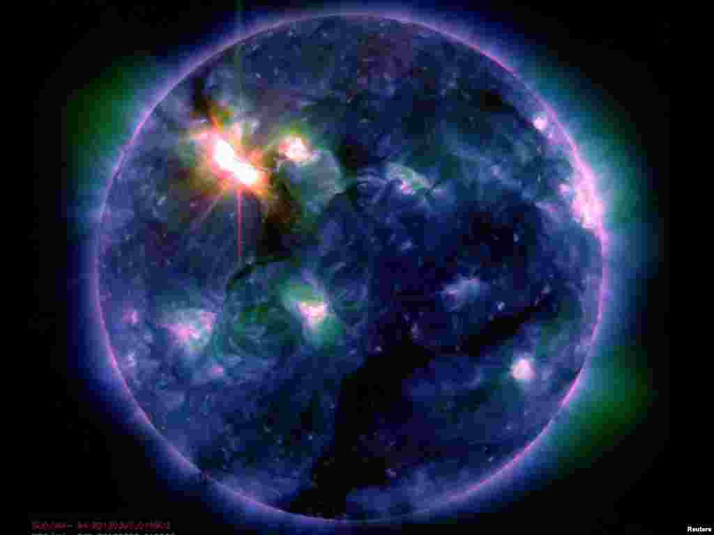 Space -- The sun erupts with one of the largest solar flares of this solar cycle in this multi-colored NASA photo, 06Mar2012
