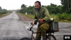 Un hombre monta su bicicleta en un camino de Minas de Matahambre (Cuba) en Pinar del Río. 