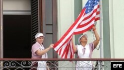 Empleadas acomodan bandera estadounidense en hotel donde llegó una comitiva de senadores de EE.UU.