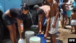 Cubanos se abastecen de agua en pipas.