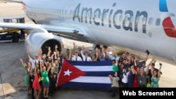 Empleados de American Airlines, que recibió permiso para 56 vuelos semanales a Cuba, posan con la bandera cubana. (Foto: American Airlines)